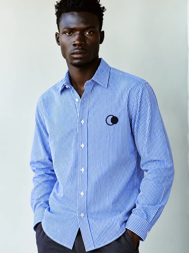 A Moontian in a blue pinstripe shirt with the dual-moon mark
